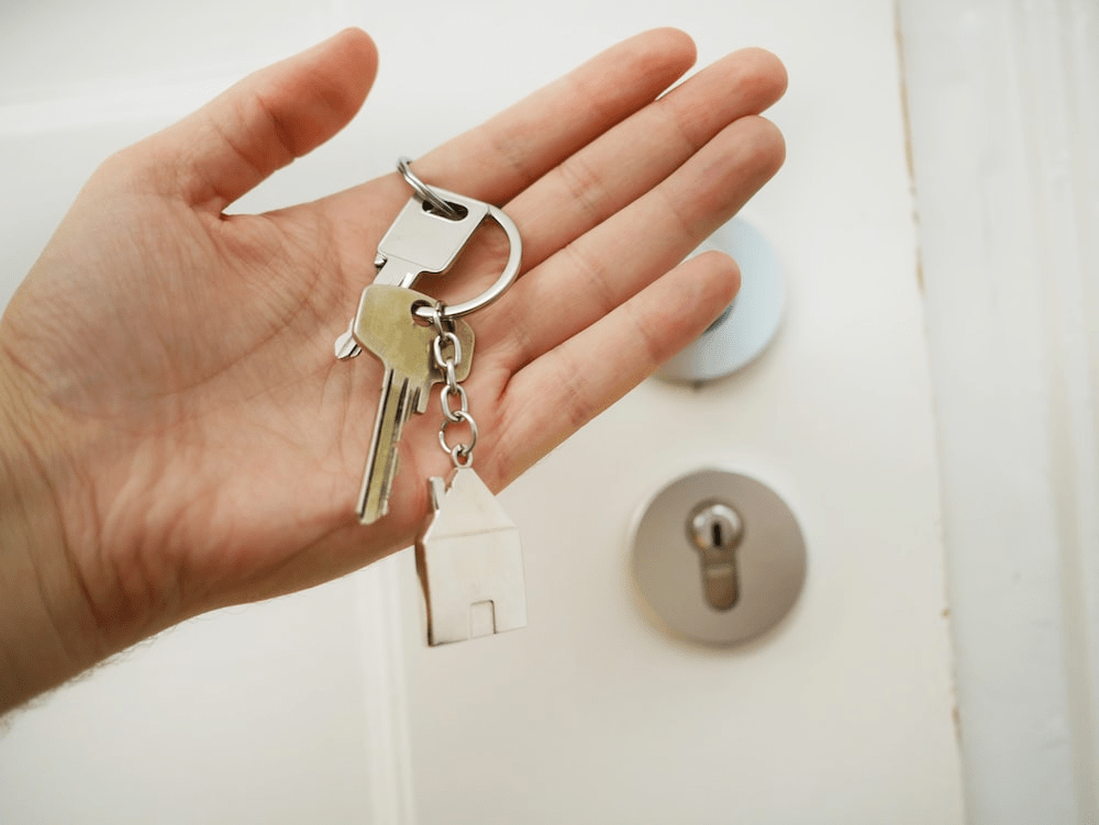 person holding keys to door